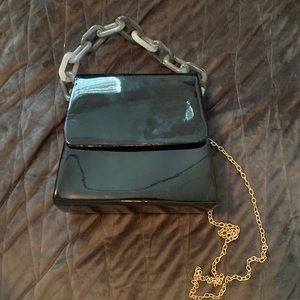 Black mini bag with chunky chain and gold crossbody chain
